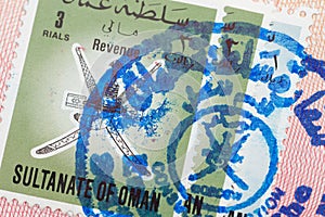 Passport page with the Sultanate of Oman visa and immigration control stamp.