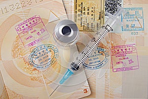 Passport pages and travel medication syringe and vial
