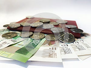 Passport with paper money and coins. Flatlay of vacation on a white background