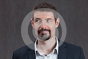 Passport photo of forties man with a goatee beard looking left