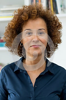 Passport photo of mature adult woman with curly hair