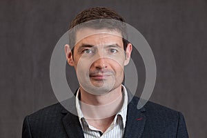 Passport photo of a smiling forties man