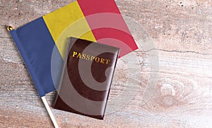 Passport and a Romania flag on a wooden background