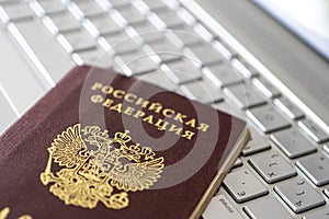 Passport of Russian Federation on a gray laptop keyboard. Identification of the user on the Internet. Prohibition of access to the