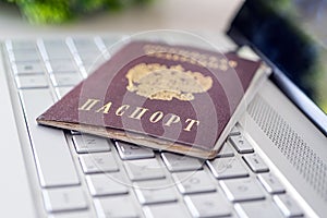 Passport of Russian Federation on a gray laptop keyboard. Identification of the user on the Internet. Prohibition of access to the