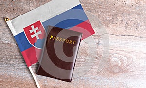 Passport and a Slovakia flag on a wooden background