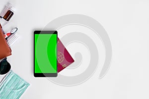Passport and smart phone with green screen. Travel concept with copy space. White background, chroma key mockup