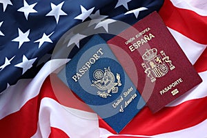 Passport of Spain with US Passport on United States of America folded flag