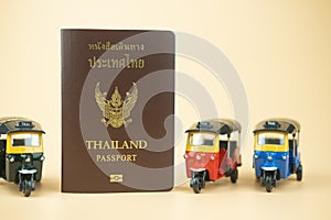 Passport for Thai citizen and tuk tuk is traditional tricycle and symbol of Thailand travelling