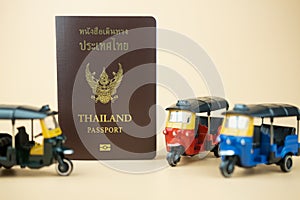 Passport for Thai citizen and tuk tuk is traditional tricycle and symbol of Thailand travelling