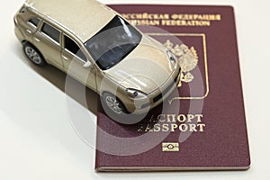 Passport and a toy car lie on the table.