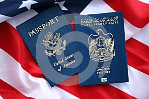 Passport of United Arab Emirates with US Passport on United States of America folded flag