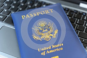 Passport of USA on Notebook keyboard, close up. Identification of the user on the Internet. Prohibition of access to the Internet