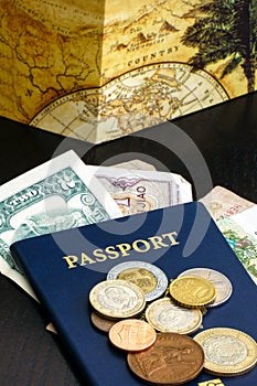 Passport with world currency on wood table