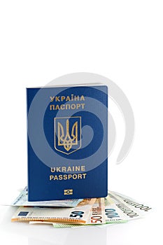 Passports of citizens of Ukraine for traveling abroad. European banknotes in ukrainian passport on the table, close up. Traveling