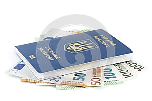 Passports of citizens of Ukraine for traveling abroad. European banknotes in ukrainian passport on the table, close up. Traveling
