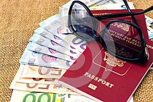 Passports with european union currency and sunglasses on a map background. Travel concept