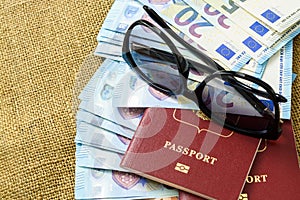 Passports with european union currency and sunglasses on a map background. Travel concept.
