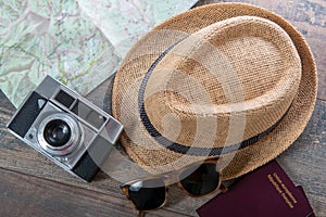 Passports, map, summer hat and camera ready for holidays