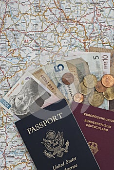 Passports and money on a map