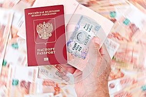 Passports of Russian Federation with Egyptian Entry Visa on the blurred background of Russian banknotes