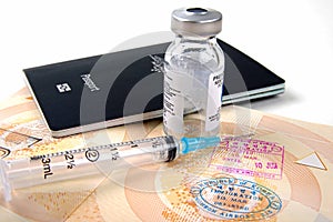 Passports and travel medication vial and syringe