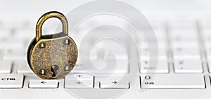 Password change, internet security banner, padlock on a white keyboard