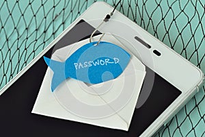 Password written on a paper note in the shape of a fish attached to a hook on an envelope and a mobile phone - Phishing and mobile