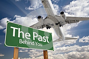 The Past Green Road Sign and Airplane Above