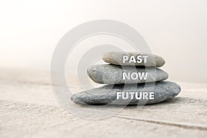 Past, Now and Future words written on stones. Motivational advice or reminder