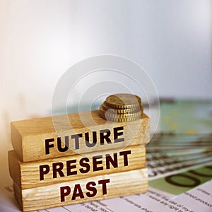 Past Present Future words on wood block. bills and coins. retirement concept