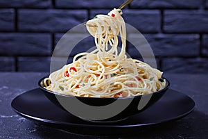 Pasta Aglio, Olio e Peperoncino on a fork photo