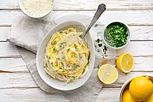 Pasta al Limone, delicious Italian meal, spaghetti with Parmesan, butter and lemon sauce, topped with fresh grated zest and cheese