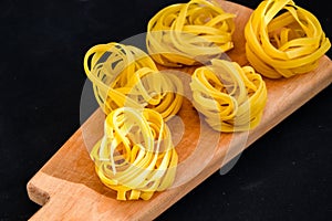 Pasta all`uovo, Tagliatelle Pasta, Round balls of raw pasta on black background