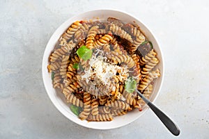 Pasta alla Norma - traditional Italian food with eggplant, tomato, cheese and basil