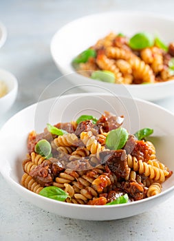 Pasta alla Norma - traditional Italian food with eggplant, tomato, cheese and basil