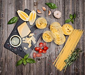 Pasta background frame with ingredients for cooking on weathered