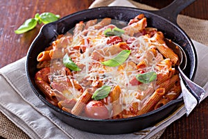 Pasta bake with penne, tomatoes and mozarella photo