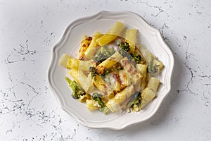 Pasta baked with broccoli and chicken. Broccoli, cheese and gratin sauce on baked penne pasta