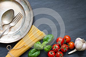 Pasta basil tomato garlic food abstract background concept on black marble