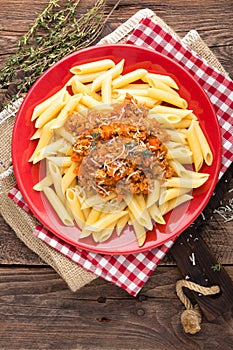 Pasta bolognese. Pasta served with a sauce of ground beef meat, tomato, onion, carrot and thyme