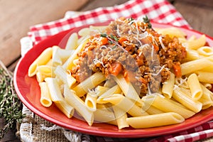 Pasta bolognese. Pasta served with a sauce of ground beef meat, tomato, onion, carrot and thyme