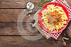 Pasta bolognese. Pasta served with a sauce of ground beef meat, tomato, onion, carrot and thyme