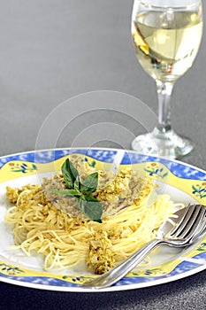 Pasta bolognese on the plate and glass of white wine