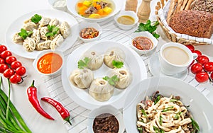 Pasta, bowls of various sauces, vegetables and soup pelmeni for lunch