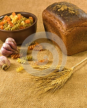 Pasta, bread, garlic and wheat closeup