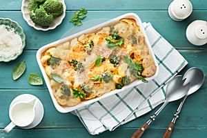 Pasta Broccoli casserole. Baked Mac and cheese with broccoli, cream sauce and parmesan on old rustic wooden background