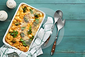 Pasta Broccoli casserole. Baked Mac and cheese with broccoli, cream sauce and parmesan on old rustic wooden background