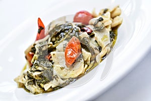 Pasta called maltagliati with turnip greens, and cherry tomatoes