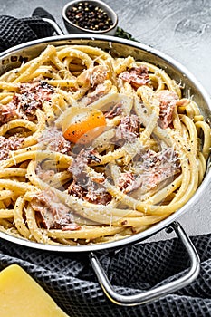Pasta Carbonara, bucatini in the pan. Gray background. Top view